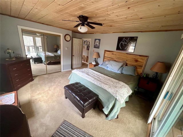 bedroom with wood ceiling, light colored carpet, and ceiling fan