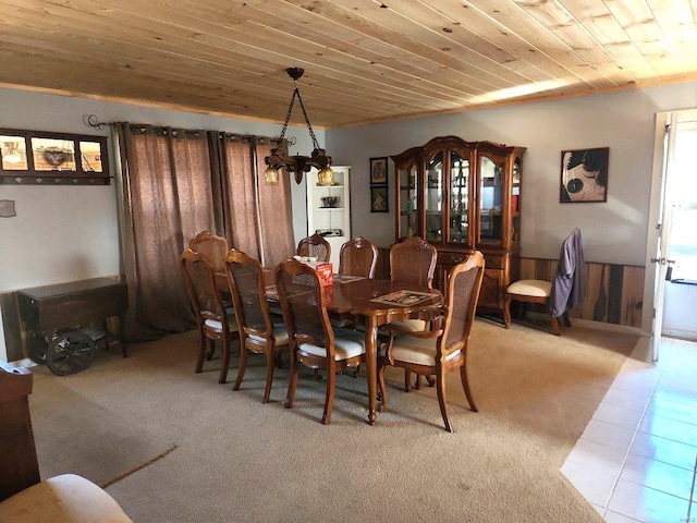 tiled dining space featuring wood ceiling