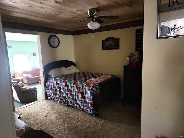 carpeted bedroom with wood ceiling and ceiling fan