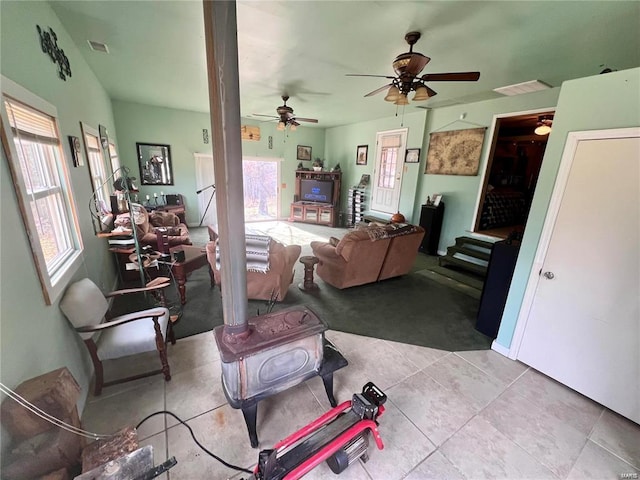 tiled living room with ceiling fan