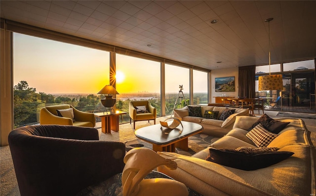 carpeted living room featuring a wall of windows and a fireplace