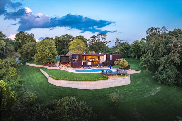 view of pool with a deck and a yard