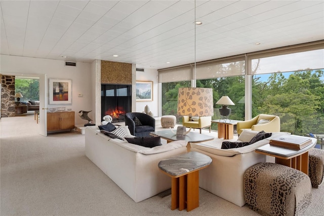 living room featuring light carpet and a fireplace