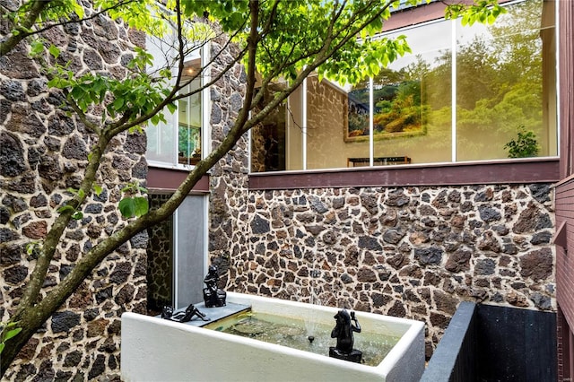 exterior space with a wealth of natural light and a tub