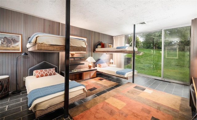 bedroom with a textured ceiling and tile patterned flooring