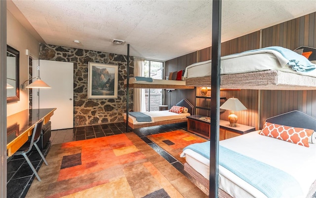 tiled bedroom featuring a textured ceiling