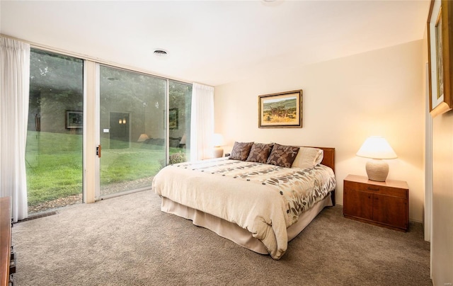 carpeted bedroom featuring expansive windows and access to outside