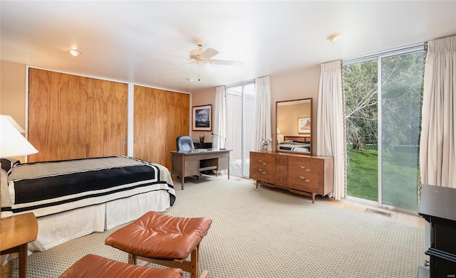 carpeted bedroom featuring ceiling fan and access to outside