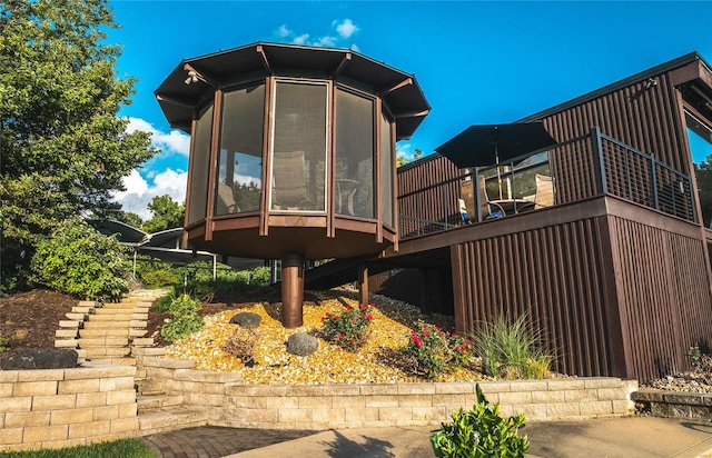 back of house featuring a sunroom