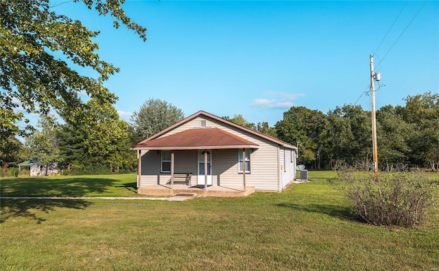 rear view of house with a yard