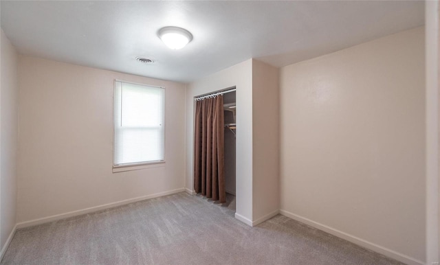 unfurnished bedroom with a closet and carpet flooring