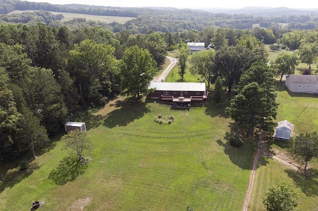 birds eye view of property featuring a forest view