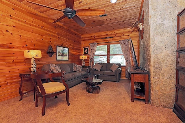 living area featuring wood ceiling, light carpet, wood walls, and visible vents