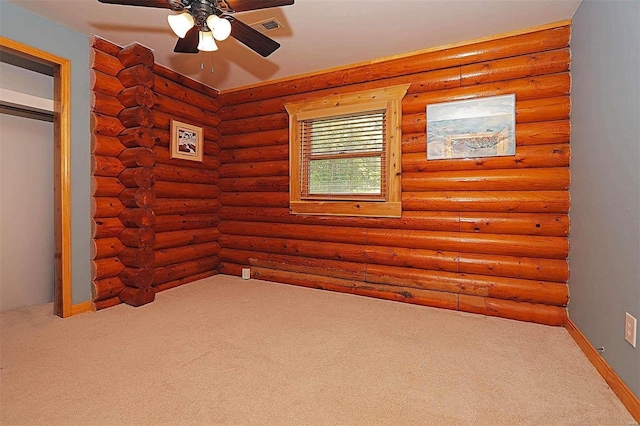 unfurnished bedroom with ceiling fan, rustic walls, carpet flooring, and visible vents