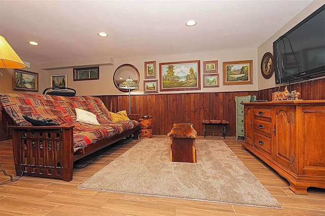 living room with wood walls, wainscoting, wood finished floors, and recessed lighting