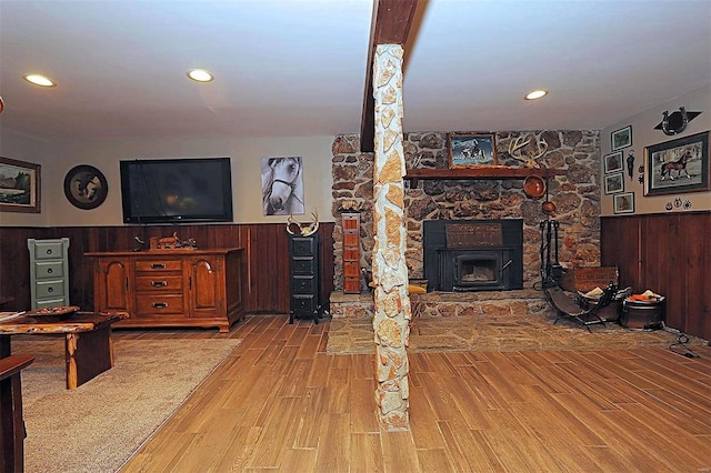 living room with a wainscoted wall, wood finished floors, and wooden walls