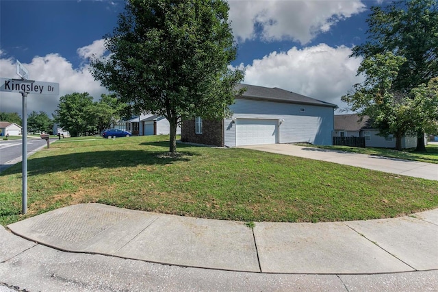 view of front of property featuring a garage and a front lawn