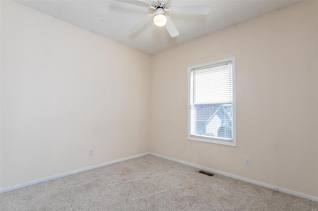 carpeted spare room featuring ceiling fan