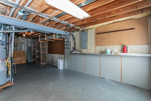 basement with gas water heater and electric panel