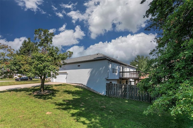 view of side of home with a garage and a yard