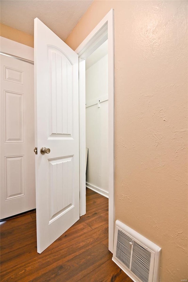 corridor featuring dark wood-type flooring