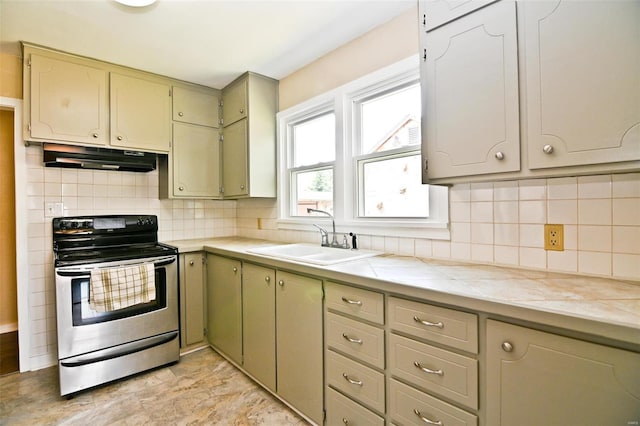 kitchen with stainless steel electric stove, light tile patterned flooring, sink, and decorative backsplash