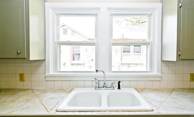 kitchen featuring tile counters and sink