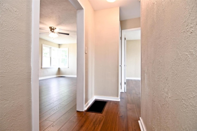 corridor with wood-type flooring