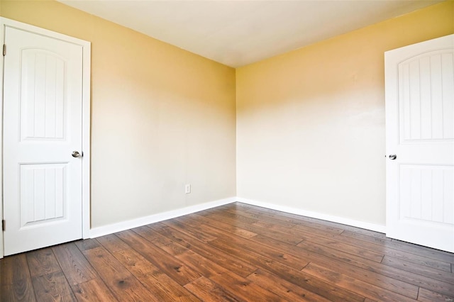 spare room with dark wood-type flooring