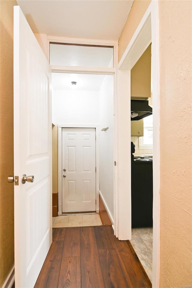 hallway with hardwood / wood-style floors