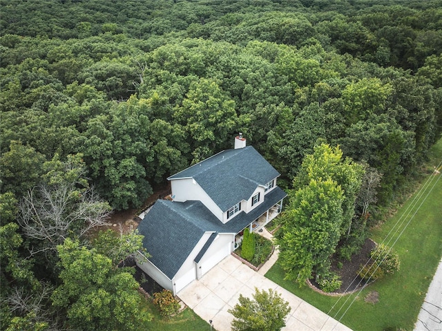 drone / aerial view featuring a view of trees