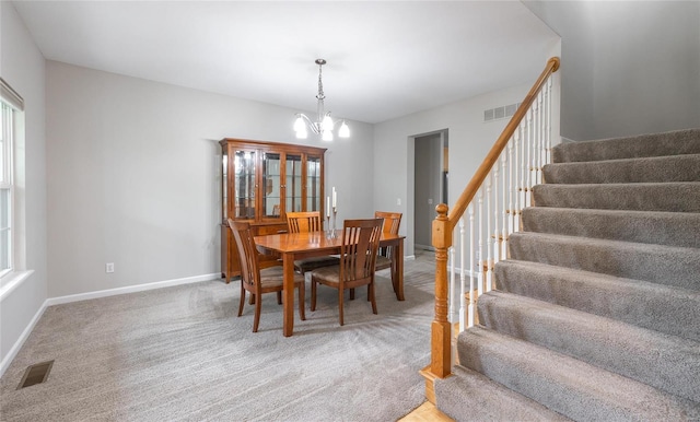 dining space with light carpet, stairway, baseboards, and visible vents