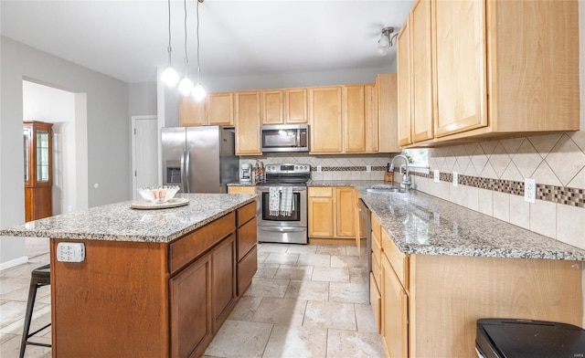 kitchen featuring a center island, stainless steel appliances, decorative backsplash, light brown cabinetry, and a sink