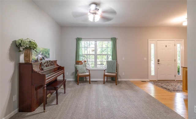 entryway featuring ceiling fan, baseboards, and wood finished floors