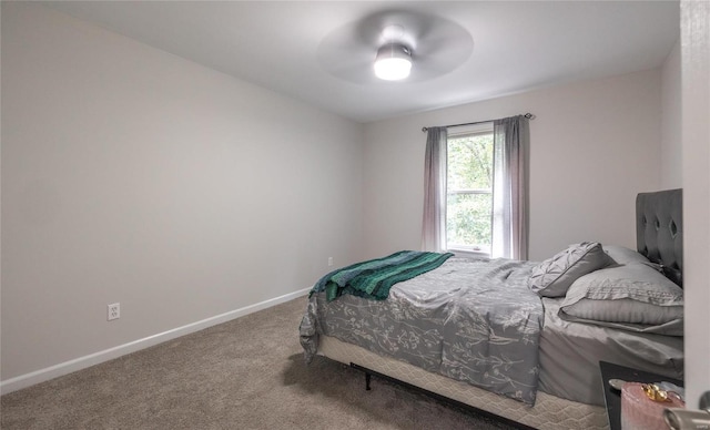 carpeted bedroom with ceiling fan and baseboards