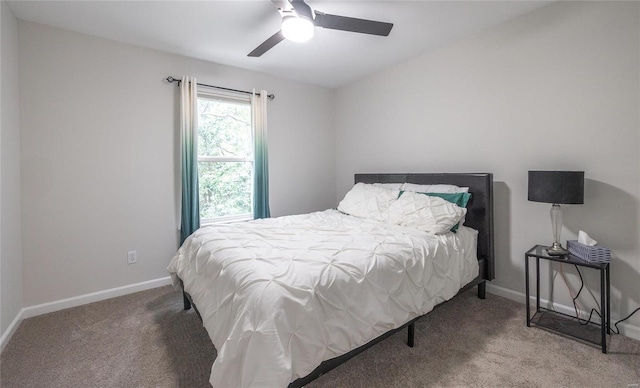 carpeted bedroom with a ceiling fan and baseboards