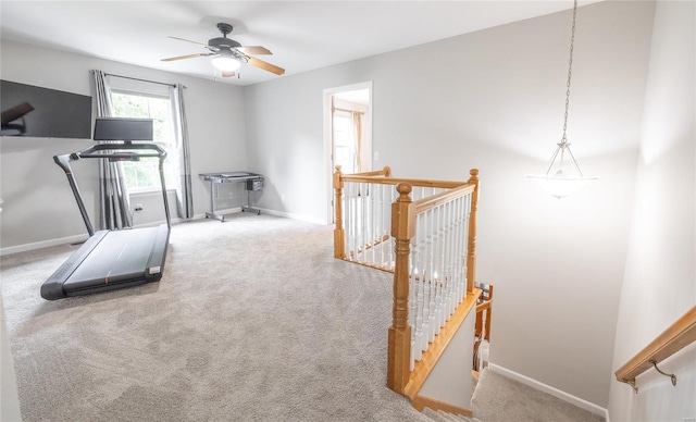 workout room featuring ceiling fan, baseboards, and carpet flooring