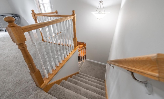 stairs featuring carpet and baseboards