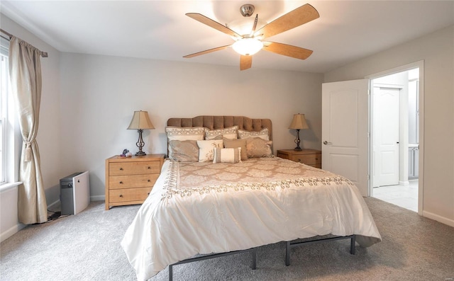 bedroom featuring ceiling fan, baseboards, and light colored carpet