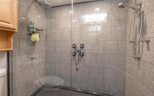 bathroom with tiled shower and toilet