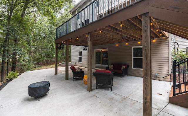 view of patio with a wooden deck and an outdoor living space