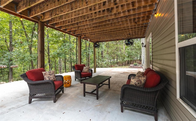 view of patio featuring a forest view and an outdoor living space