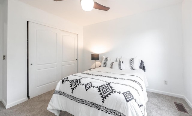 bedroom with carpet, a closet, visible vents, and baseboards