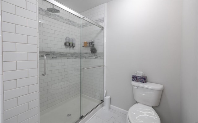 bathroom with marble finish floor, baseboards, a shower stall, and toilet