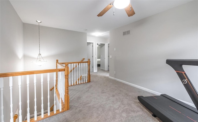 exercise area with a ceiling fan, carpet flooring, visible vents, and baseboards