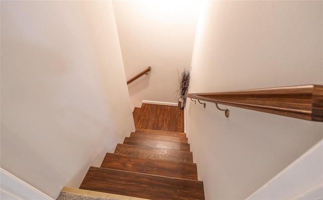 stairs featuring wood finished floors