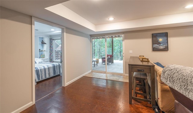 interior space with baseboards, wood finished floors, and recessed lighting