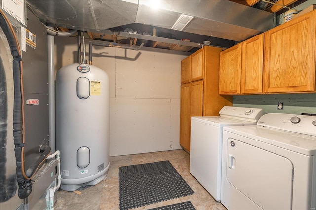 washroom with cabinet space, washer and clothes dryer, heating unit, and water heater