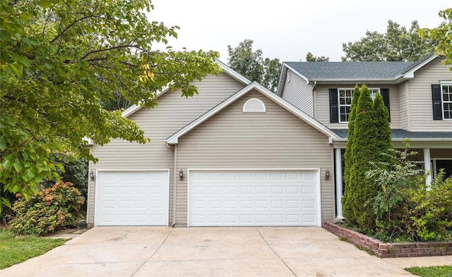 view of front of home with a garage and concrete driveway