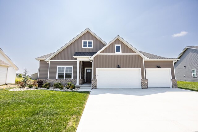 view of front of home featuring a front yard and a garage